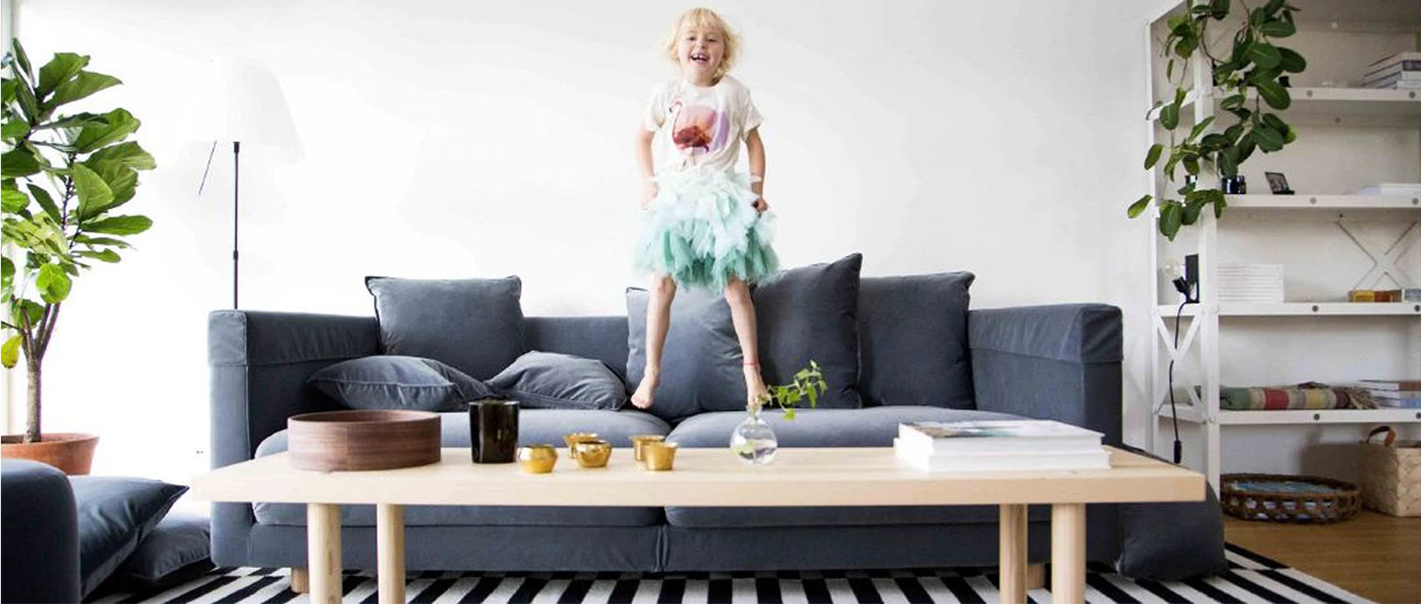 child jumping in sofa
