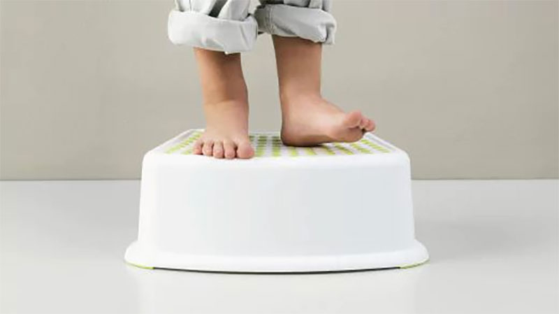 child standing on a stool