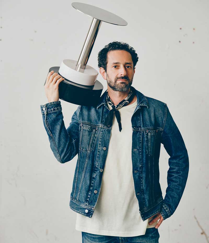 Close up of Emanuele Stamuli holding a black and white object designed for IKEA KONSTRUNDA art collection.