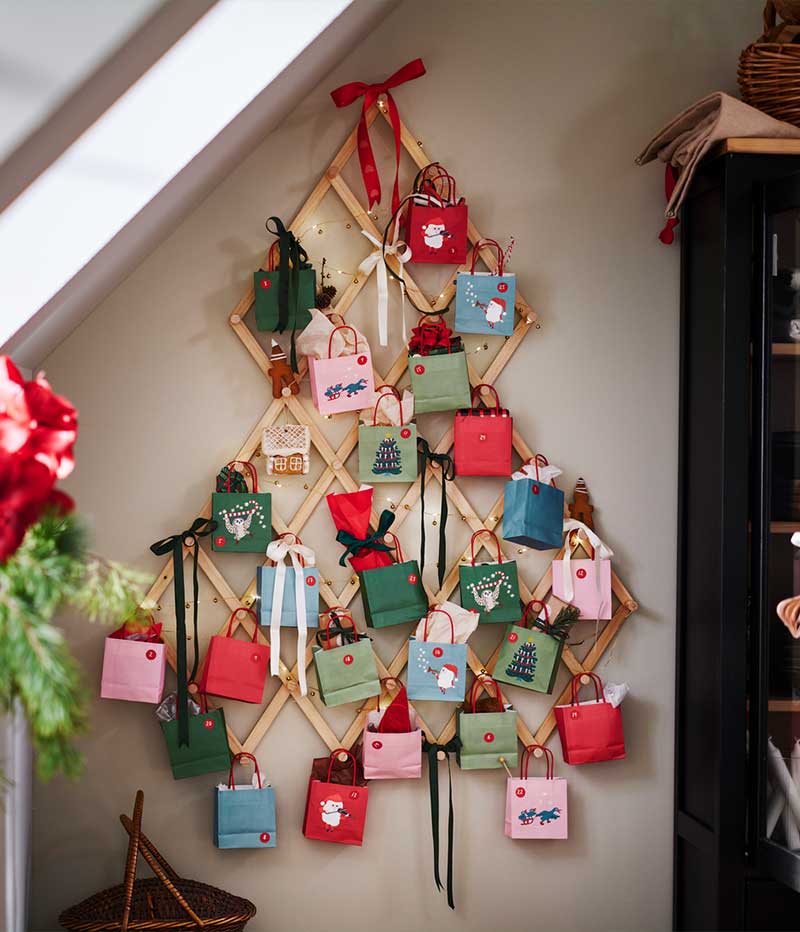 On a wall is a VINTERFINT tree-shaped wall decoration with baubles and VINTERFINT tree decorations.