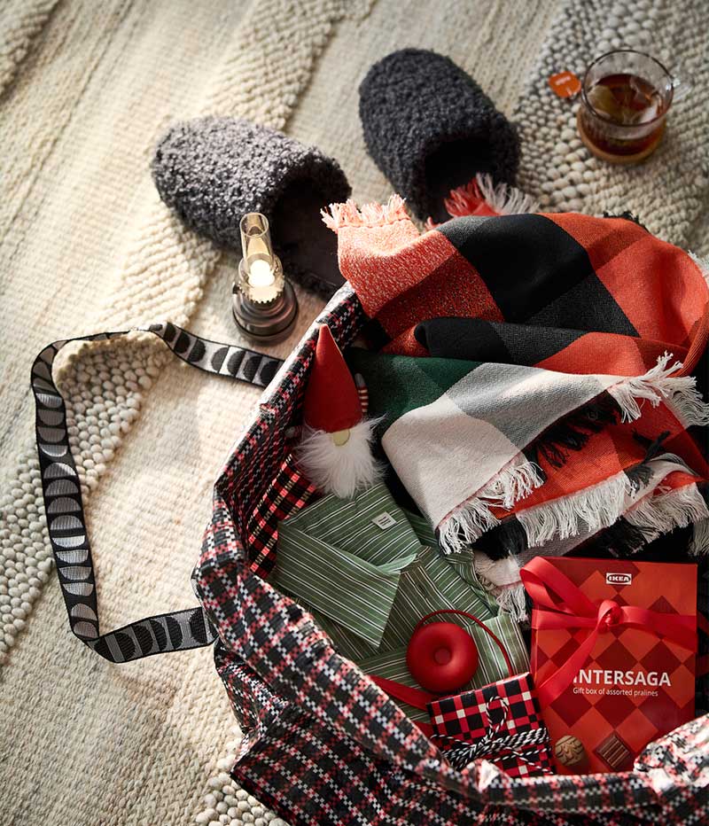 IKEA Christmas bag with a blanket and slippers on the floor